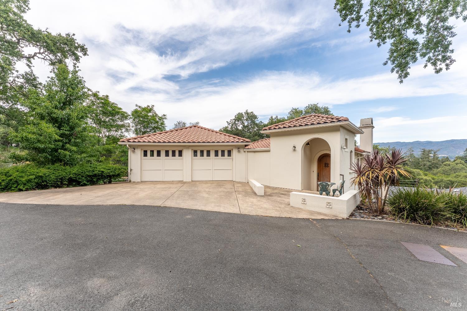 a view of a house with a yard and garage