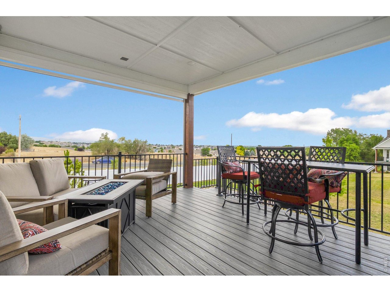 5705 2nd Road Greeley, CO 80634 - Photo 36 of 46 There are excellent mountain views from the covered back Trex deck which also has a staircase leading to the dog run below with a gate opening