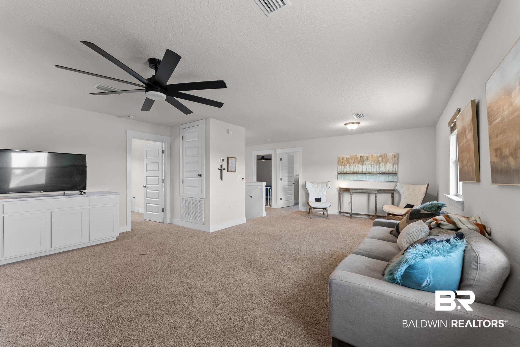 16607 Prado Loop Loxley, AL 36551 - Photo 20 of 46 Spacious carpeted room featuring a large ceiling fan, recessed lighting, and white trim