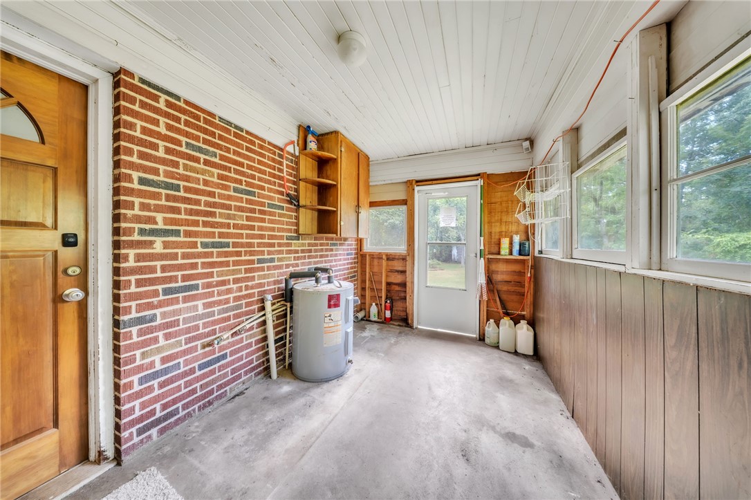 107 Burton Road Anderson, SC 29625 - Photo 23 of 33 Exposed brick accents and wood paneling line this versatile utility porch entryway.