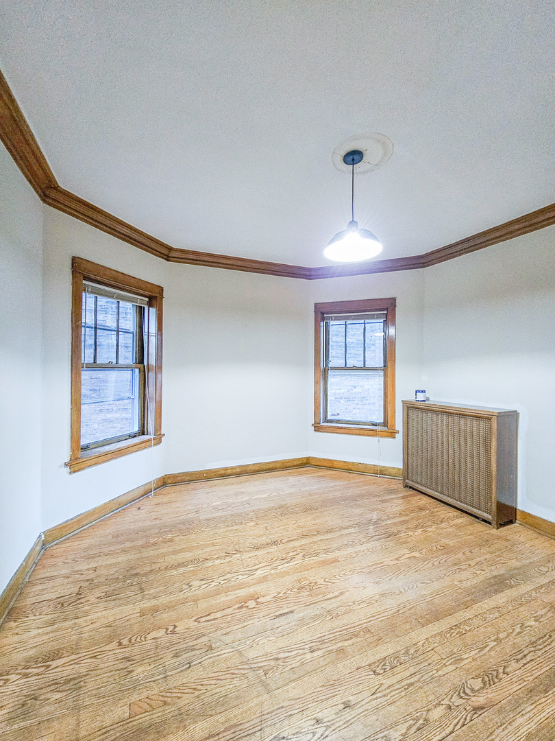 3338 West Cullom Avenue, Unit 1 Chicago, IL 60618 - Photo 5 of 14 a view of an empty room with a window
