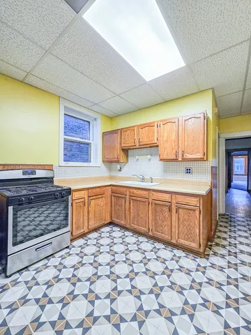 a kitchen with stainless steel appliances wooden cabinets and a sink