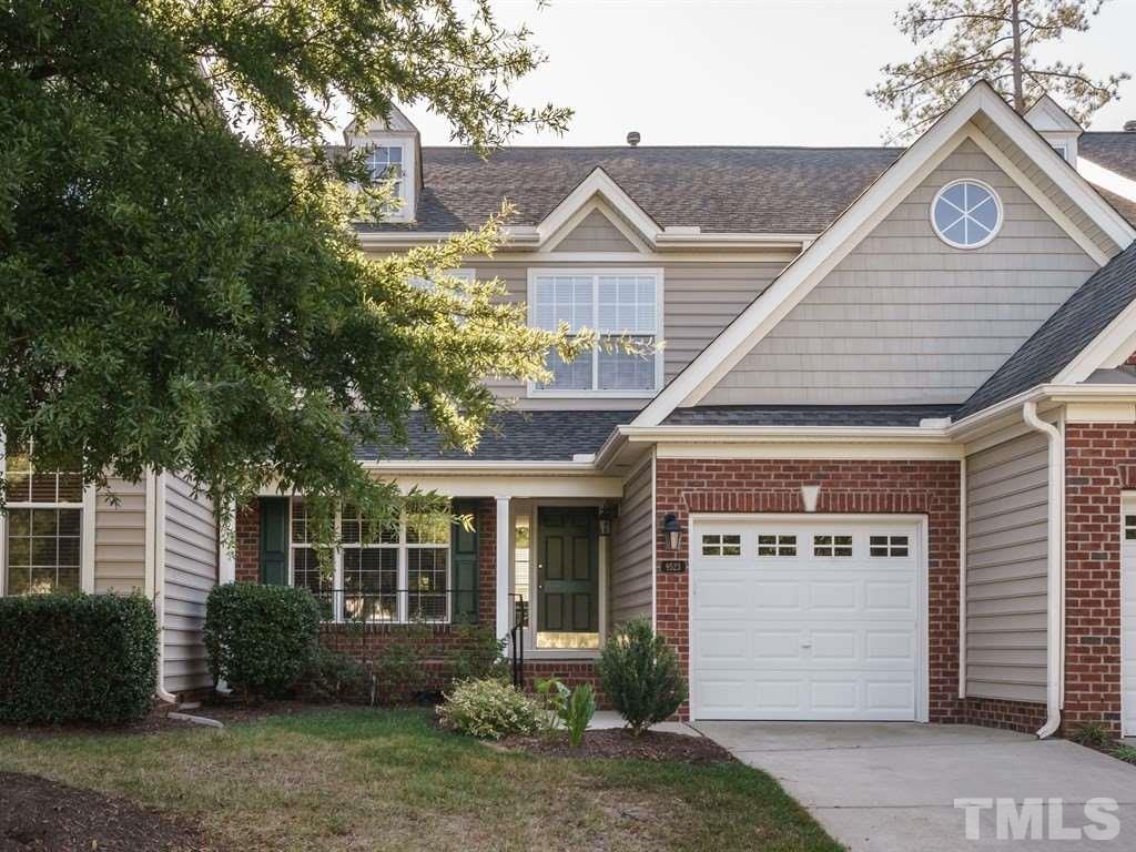 9523 Vira Drive Raleigh, NC 27617 - Photo 1 of 25 a front view of a house with a garden