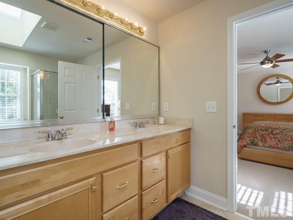 9523 Vira Drive Raleigh, NC 27617 - Photo 16 of 25 a en suite bathroom with 2 sink and a mirror