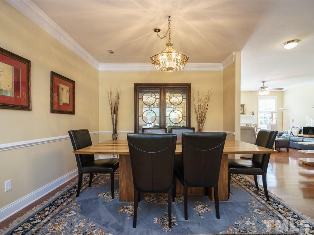 9523 Vira Drive Raleigh, NC 27617 - Photo 5 of 25 a view of a dining room with furniture a chandelier and wooden floor