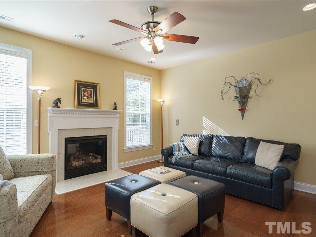9523 Vira Drive Raleigh, NC 27617 - Photo 7 of 25 a living room with furniture and a fireplace