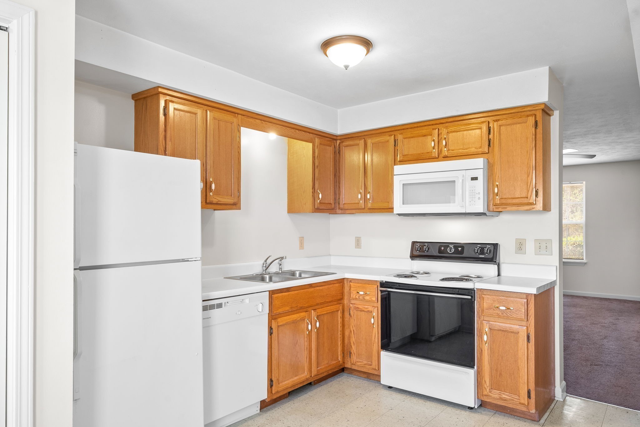 690 Needmore Road, Unit D Clarksville, TN 37040 - Photo 9 of 24 a kitchen with a stove a sink and a refrigerator