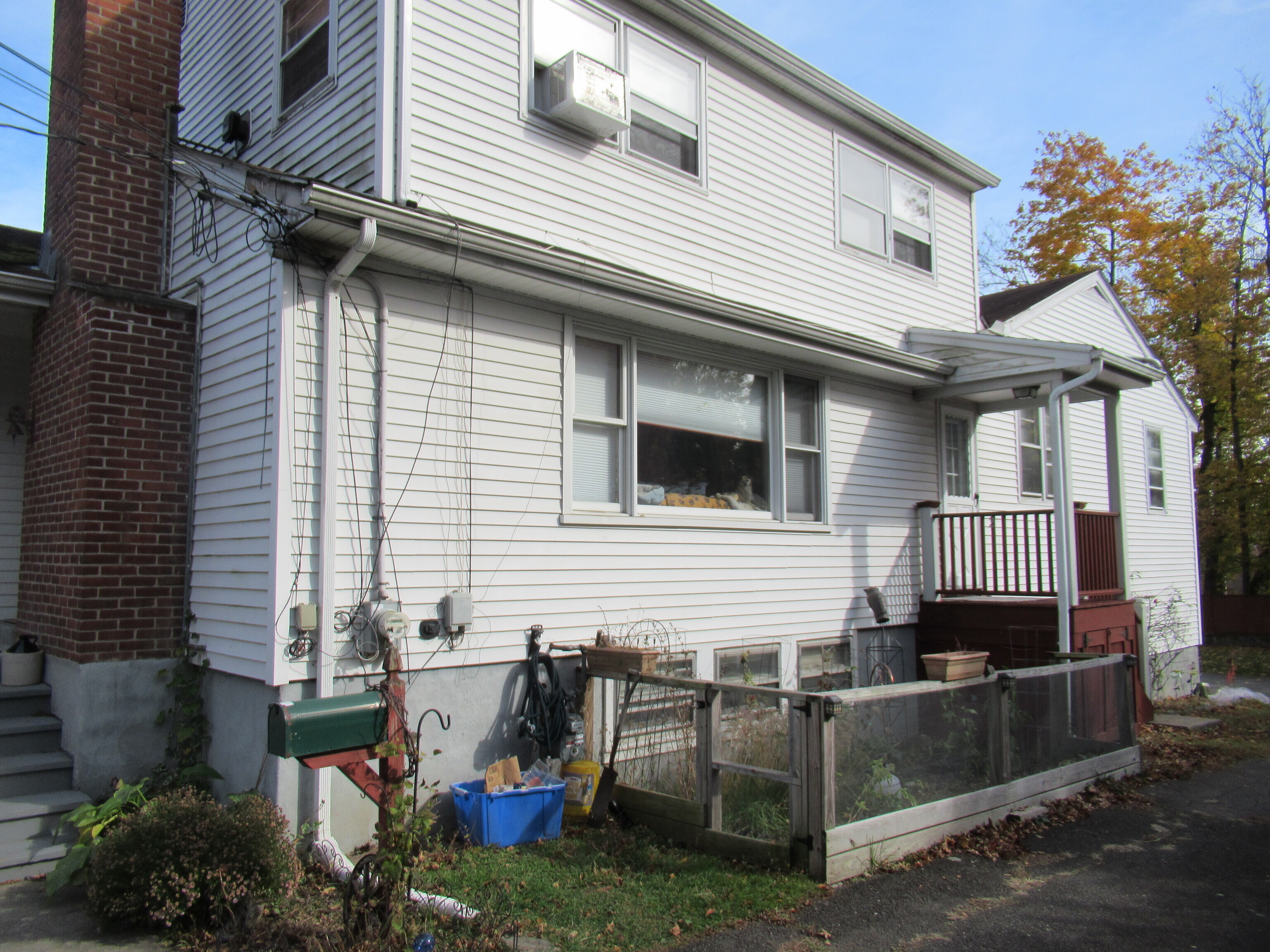 a view of a house with a patio and a yard