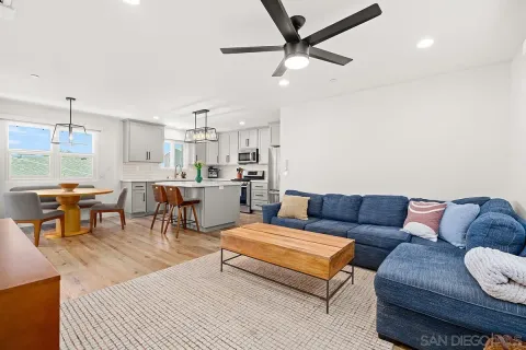 a living room with furniture and kitchen view