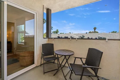 a view of a balcony with furniture and a floor to ceiling window