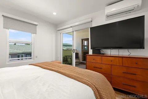a bedroom with a bed and a flat screen tv