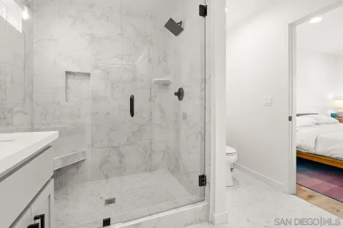 a bathroom with a tub and a view of front door