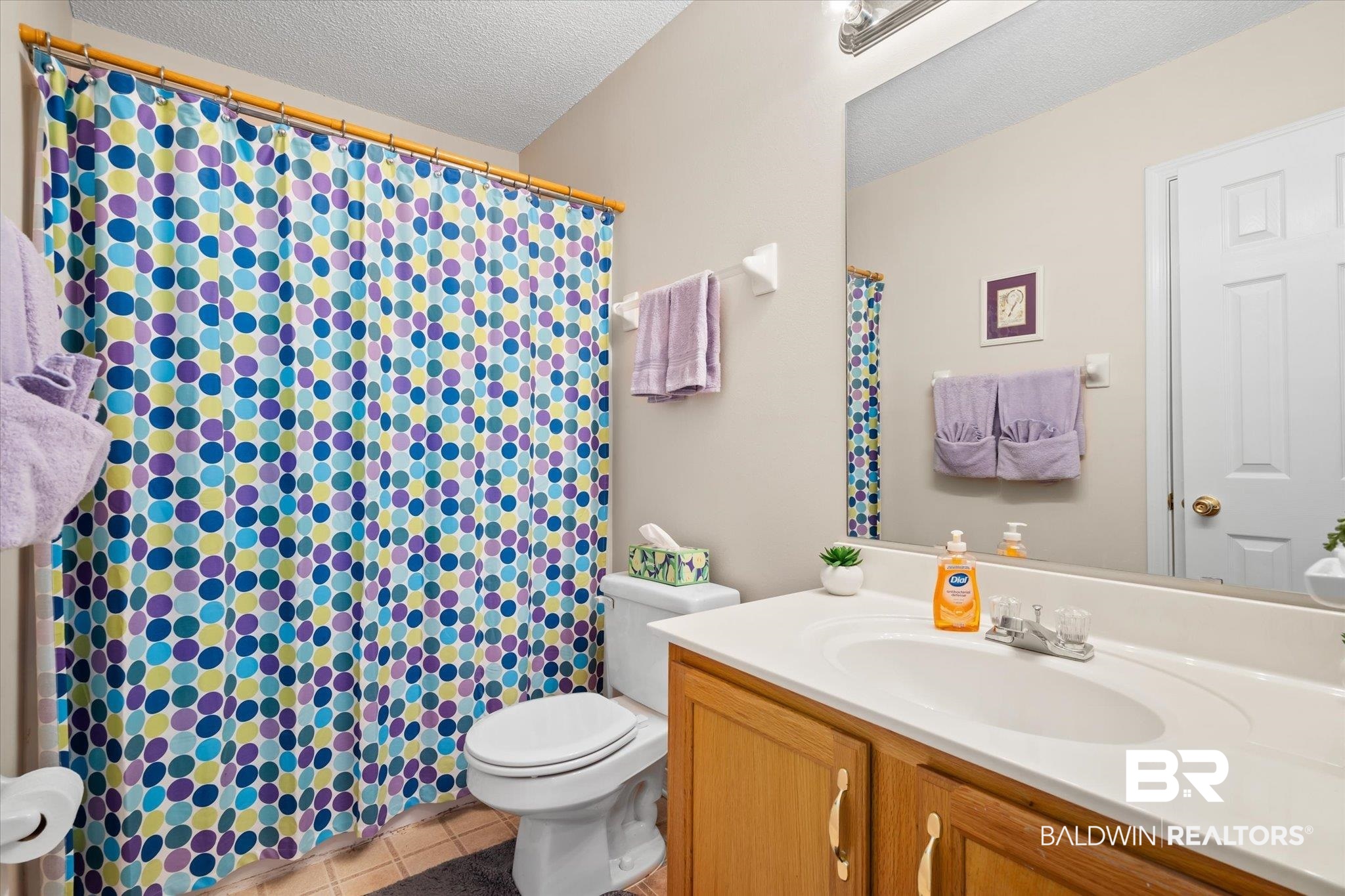 8374 Kipling Court Mobile, AL 36695 - Photo 15 of 20 Bathroom with vanity, tile patterned floors, toilet, and a textured ceiling