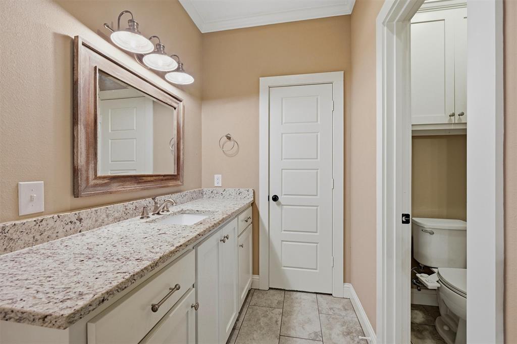 662 Preakness Place Road Van Alstyne, TX 75495 - Photo 15 of 39 a bathroom with a granite countertop sink and a mirror