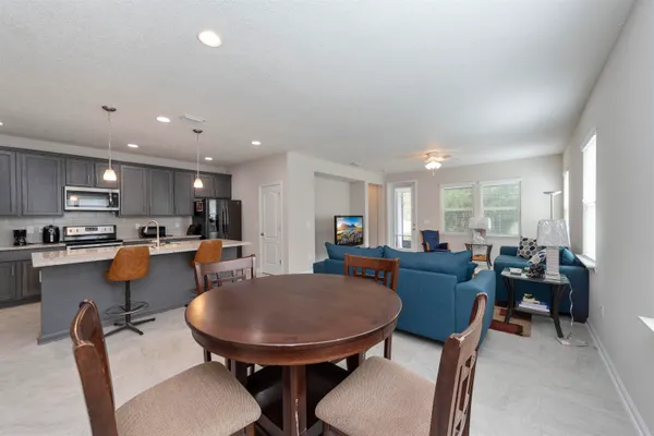 a view of kitchen with dining table and chairs