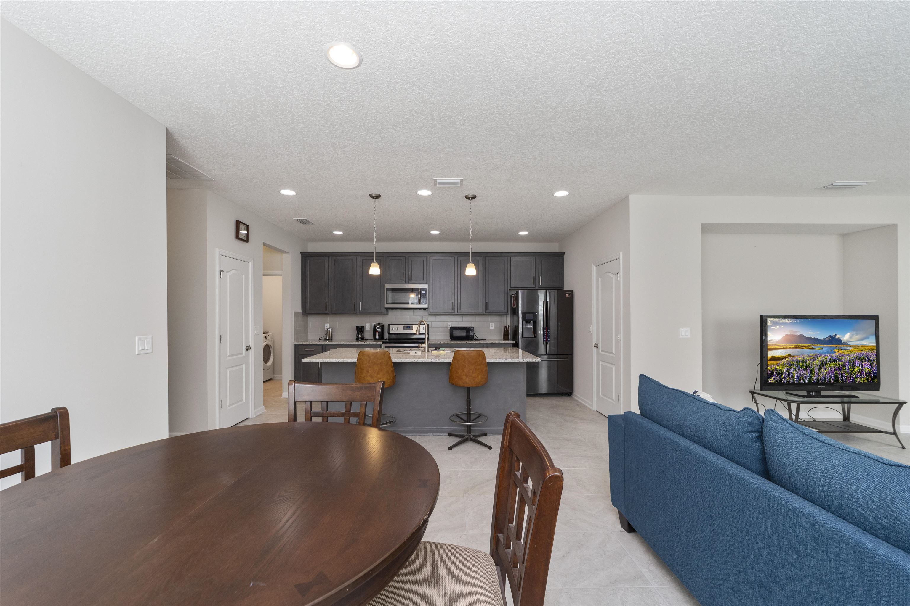 850 East Watson Road St. Augustine, FL 32086 - Photo 15 of 38 a living room with furniture and a flat screen tv