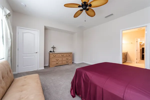 a bedroom with a bed and window