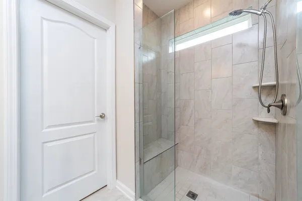 a bathroom with a glass shower door