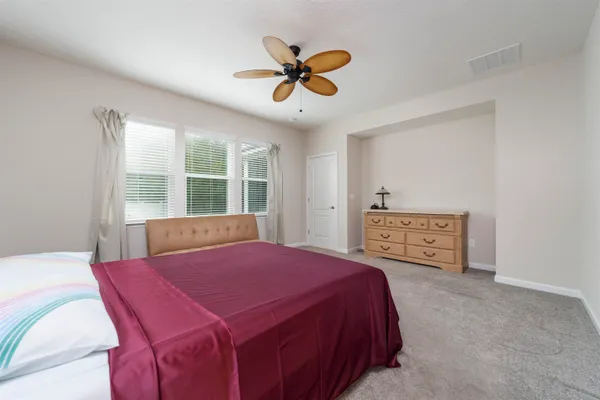 a bed room with a bed and a window