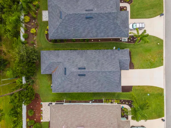 an aerial view of a house with a yard