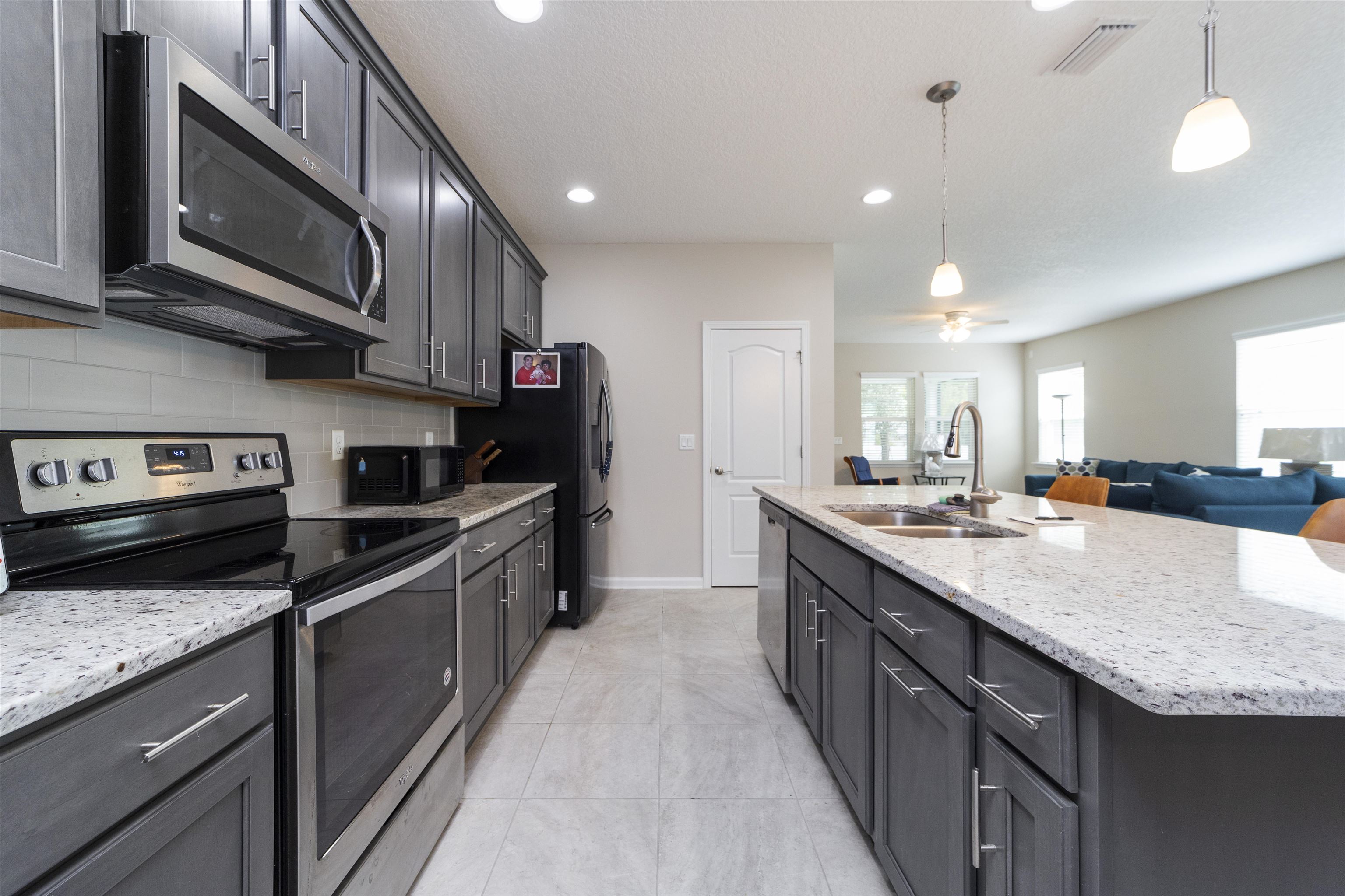 850 East Watson Road St. Augustine, FL 32086 - Photo 10 of 38 a large kitchen with stainless steel appliances granite countertop a stove a sink and a microwave