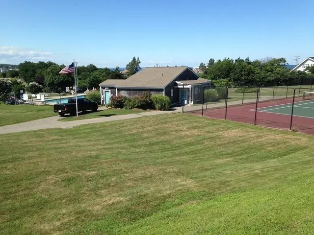 a view of a house with a yard and sitting area