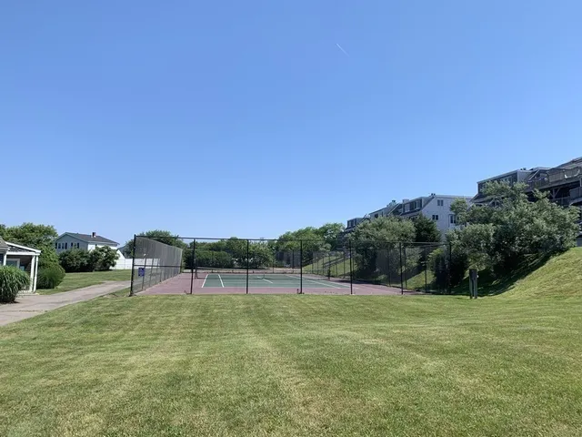 a view of a green field with wooden fence