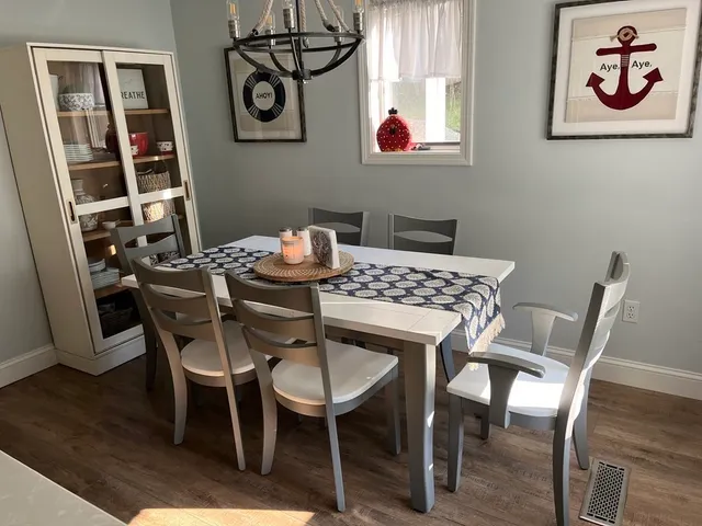 a view of a dining room with furniture and wooden floor