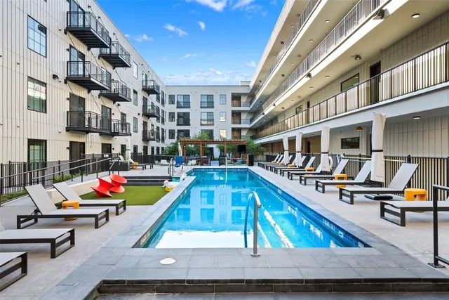 a swimming pool with outdoor seating