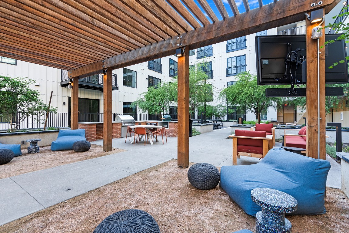 4315 South Congress Avenue, Unit 433 Austin, TX 78745 - Photo 18 of 23 a outdoor space with patio the couches and a dining table with chairs