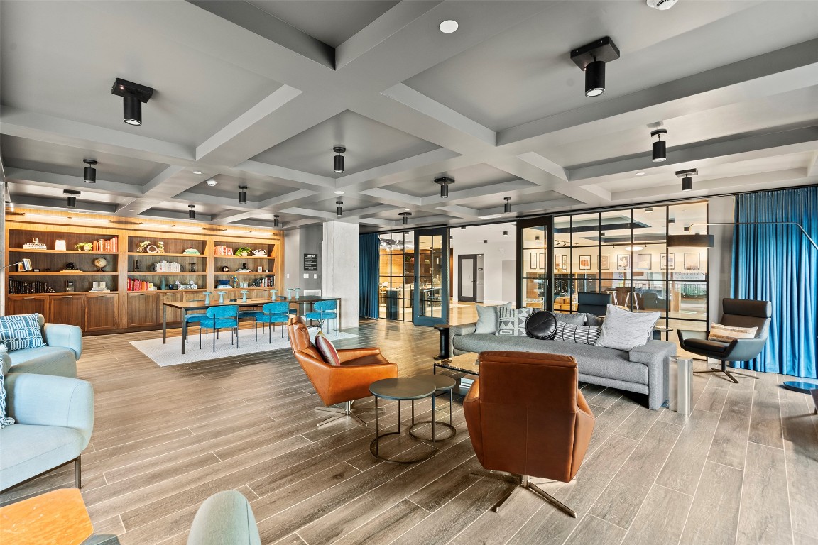 4315 South Congress Avenue, Unit 433 Austin, TX 78745 - Photo 22 of 23 a living room with lots of furniture wooden floor and large windows