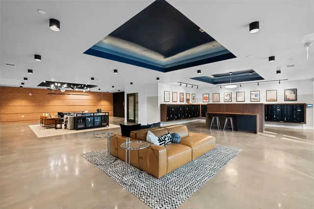a living room with furniture a flat screen tv and kitchen view