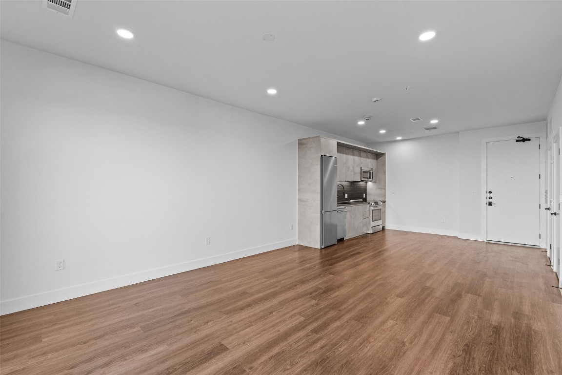 4315 South Congress Avenue, Unit 433 Austin, TX 78745 - Photo 7 of 23 a view of empty room with wooden floor
