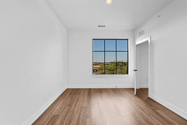 a view of wooden floor and windows in a room