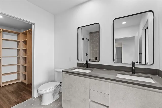 a bathroom with a toilet a sink and mirror