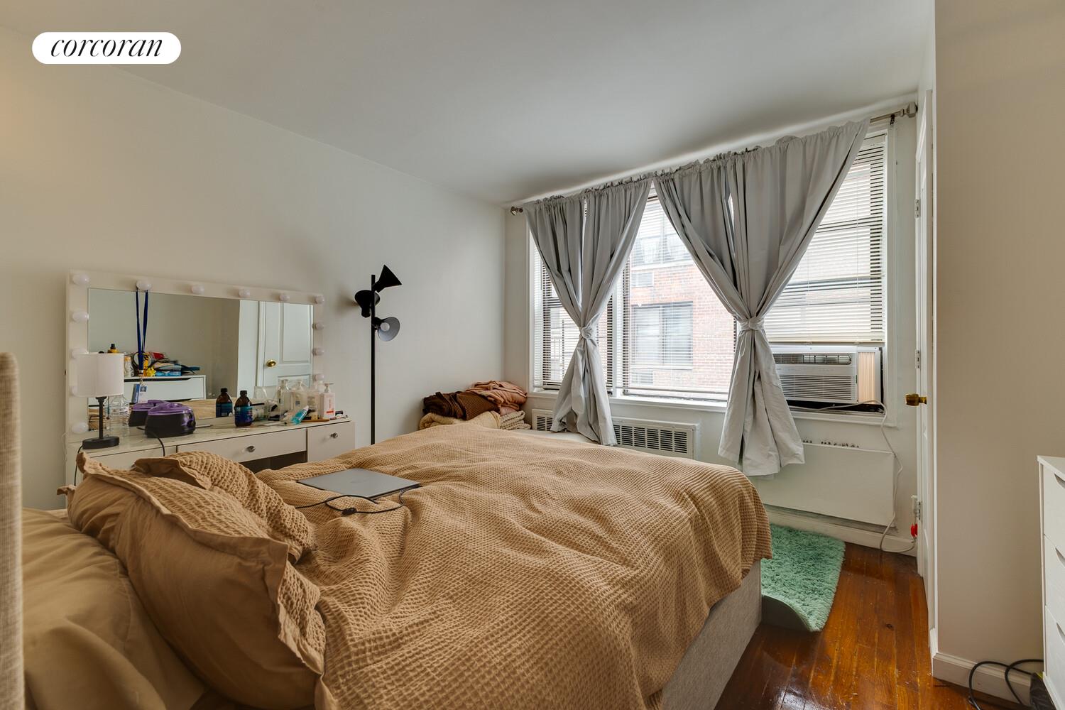 310 Lenox Road, Unit 5U Brooklyn, NY 11226 - Photo 11 of 14 a bed sitting in a bedroom next to a window