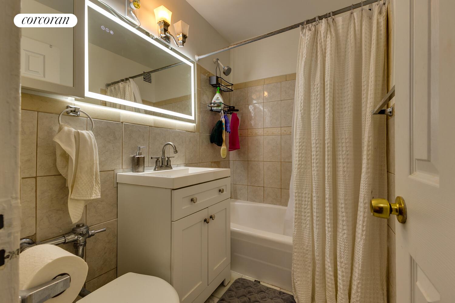 310 Lenox Road, Unit 5U Brooklyn, NY 11226 - Photo 8 of 14 a bathroom with a sink toilet and shower