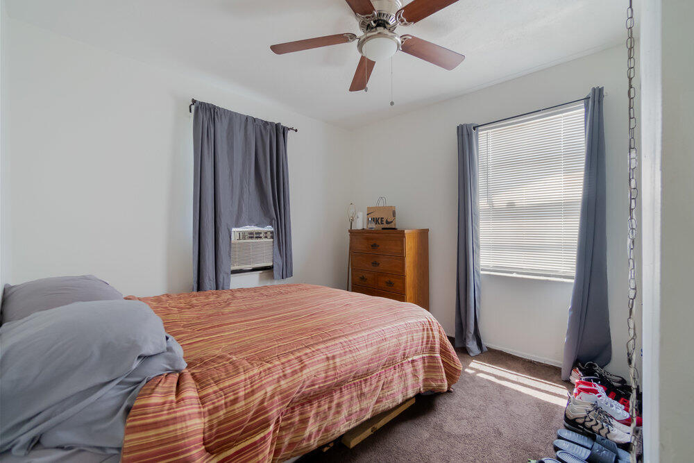 1564 West 20th Street Riviera Beach, FL 33404 - Photo 14 of 23 a bedroom with a bed and a chandelier