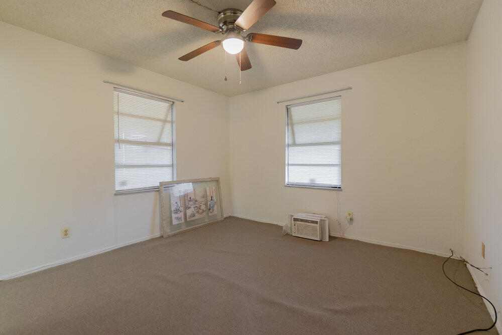 1564 West 20th Street Riviera Beach, FL 33404 - Photo 16 of 23 an empty room with windows and fan