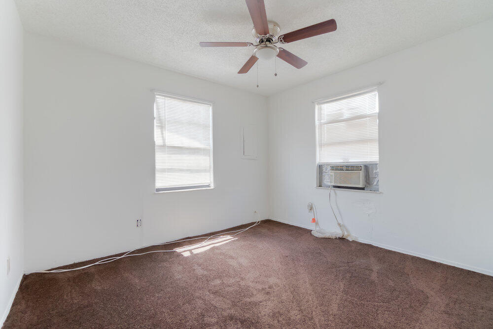 1564 West 20th Street Riviera Beach, FL 33404 - Photo 17 of 23 an empty room with windows and fan