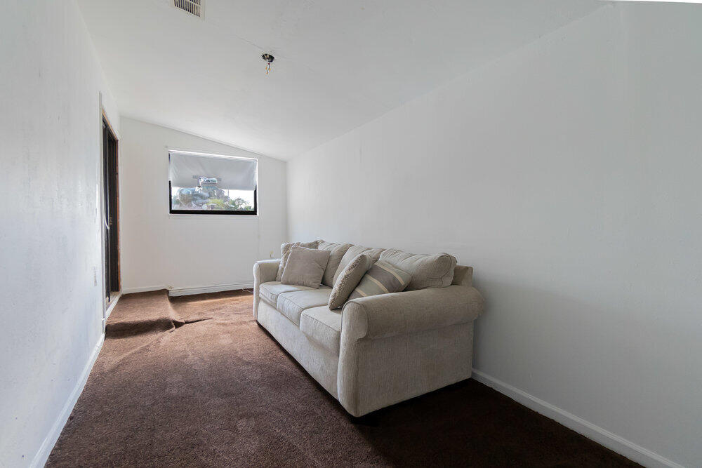 1564 West 20th Street Riviera Beach, FL 33404 - Photo 20 of 23 a living room with furniture and a wall painting