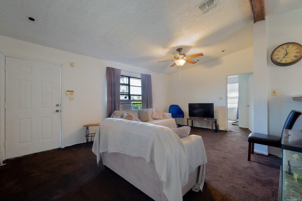 1564 West 20th Street Riviera Beach, FL 33404 - Photo 5 of 23 a room with a bed and a chandelier