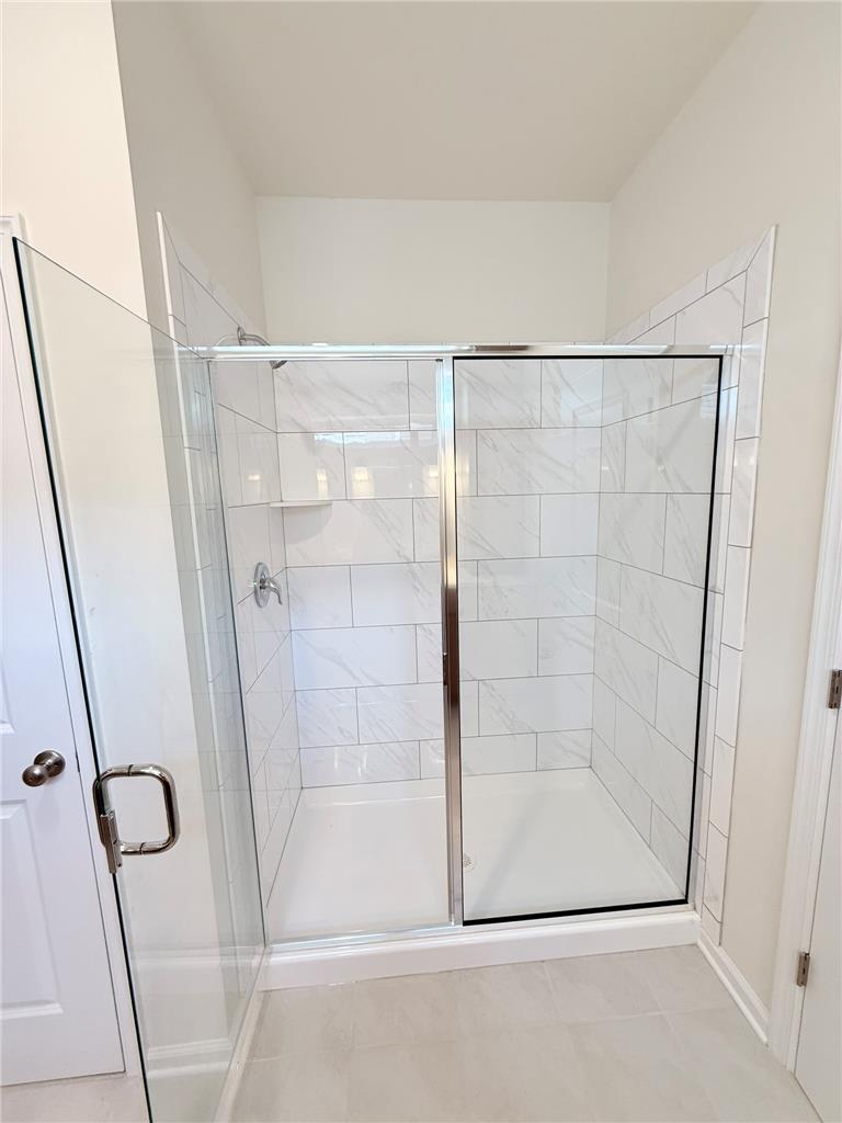 328 Abby Road, Unit LOT 15 Macungie, PA 18062 - Photo 10 of 26 A well-appointed shower stall features sleek tile walls and a clear glass enclosure.