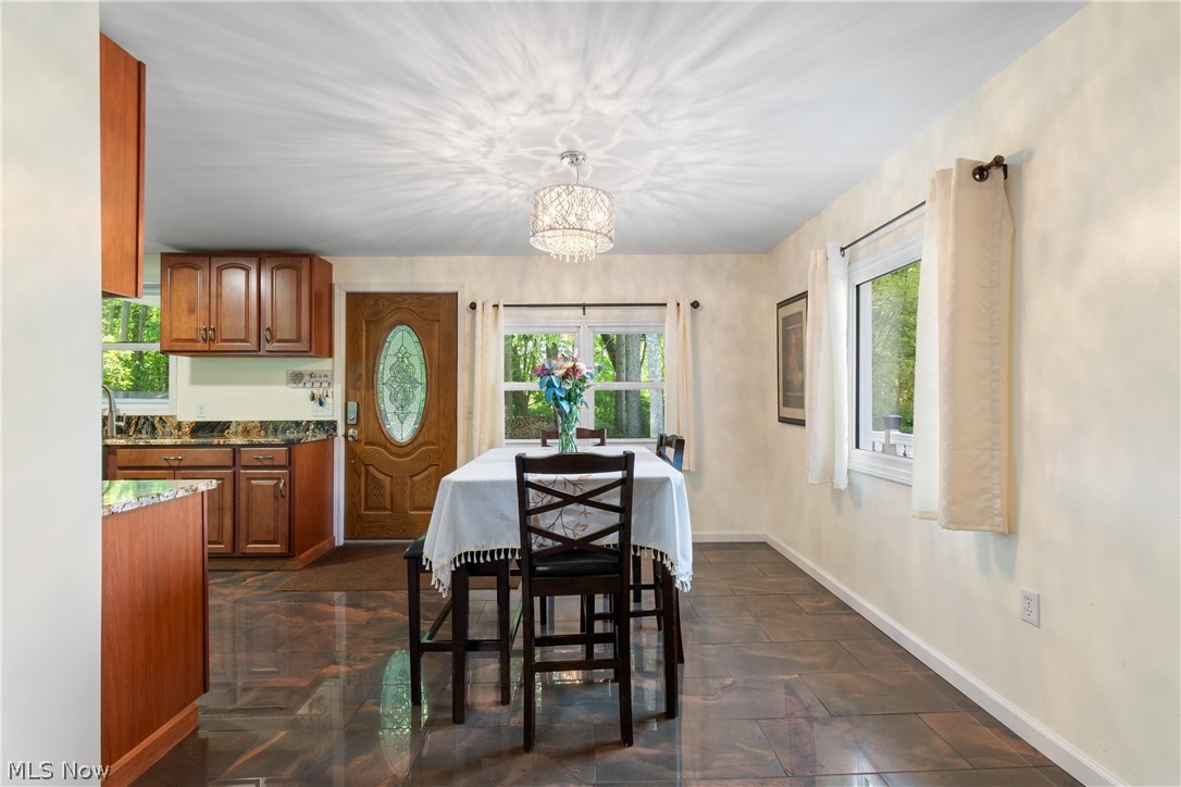 3255 Old Weymouth Road Medina, OH 44256 - Photo 9 of 31 Tiled dining room featuring a notable chandelier