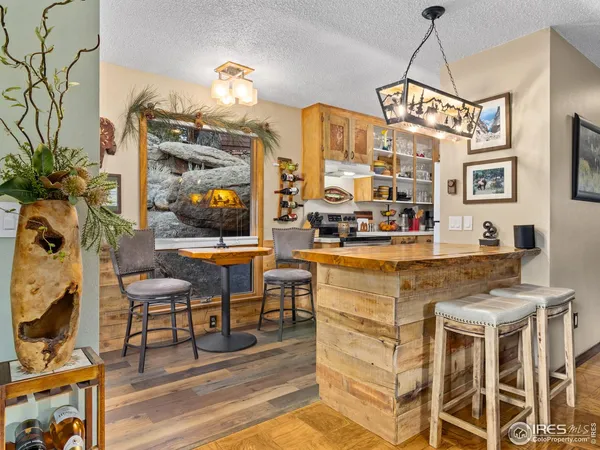 a kitchen with stainless steel appliances a stove a sink a dining table and chairs