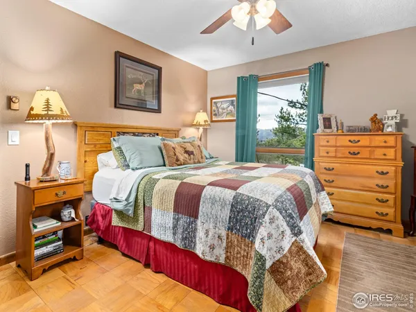 a bedroom with a bed and a large window with outer view