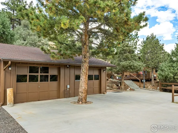 a view of a wooden house with a bench and floor to ceiling window