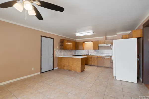 a large kitchen with a refrigerator a microwave and a stove