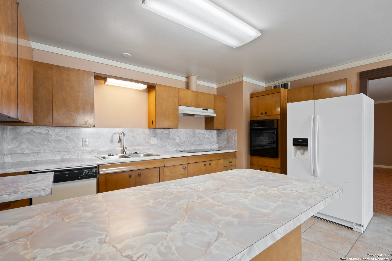203 Margaret Lane Del Rio, TX 78840 - Photo 17 of 42 a large kitchen with granite countertop a sink stove and refrigerator
