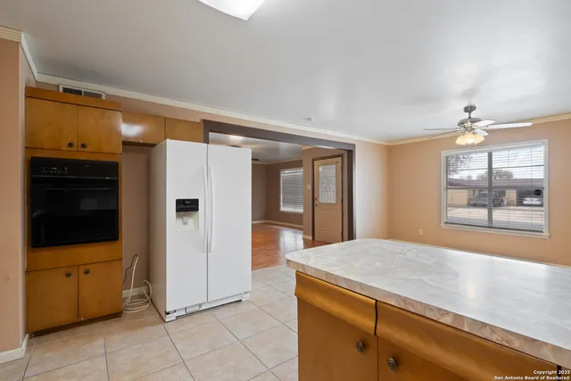 a kitchen with a refrigerator and window